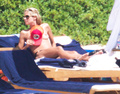 Heidi Klum sunbathing topless in Sardinia (8/2011)
