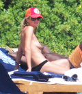Heidi Klum sunbathing topless in Sardinia (8/2011)