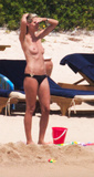 Heidi Klum sunbathing topless in Sardinia (8/2011)