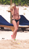 Heidi Klum sunbathing topless in Sardinia (8/2011)