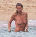 Heidi Klum sunbathing topless in Sardinia (8/2011)
