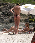 Charlize Theron - sunbathing topless in Brazil (1/2005)