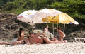 Charlize Theron - sunbathing topless in Brazil (1/2005)