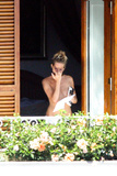 Sienna Miller - topless on balcony (7/2008)