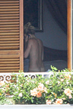 Sienna Miller - topless on balcony (7/2008)