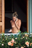 Sienna Miller - topless on balcony (7/2008)
