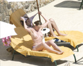 Toni Collette topless sunbathing (12/2005)