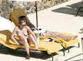 Toni Collette topless sunbathing (12/2005)
