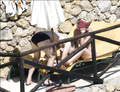 Toni Collette topless sunbathing (12/2005)