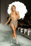 Joy Corrigan walks the runway topless with pasties during Beach Bunny show in