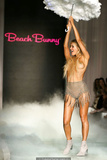 Joy Corrigan walks the runway topless with pasties during Beach Bunny show in