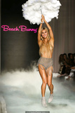 Joy Corrigan walks the runway topless with pasties during Beach Bunny show in