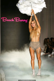 Joy Corrigan walks the runway topless with pasties during Beach Bunny show in