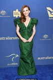 Isla Fisher cleavage in green dress at 2019 Australians In Film Awards in Los