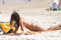 Elena Furiase sunbathing topless on a beach