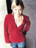 English singer and songwriter Dido in jeans and red blouse for Pat Pope