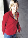 English singer and songwriter Dido in jeans and red blouse for Pat Pope