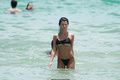 Destiny Sierra bottom of boobs in a tiny black bikini at the beach in Miami