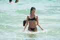 Destiny Sierra bottom of boobs in a tiny black bikini at the beach in Miami