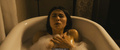 Daniella Pineda in a bathtub scenes from Mercy Black (2019)