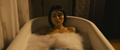 Daniella Pineda in a bathtub scenes from Mercy Black (2019)