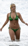 Brooke Hogan in green bikini on a beach