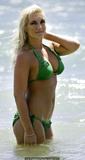 Brooke Hogan in green bikini on a beach
