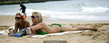 Brooke Hogan in green bikini on a beach