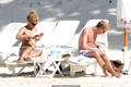 Billie Piper relaxing topless at the beach - April 22, 2008