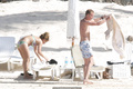 Billie Piper relaxing topless at the beach - April 22, 2008