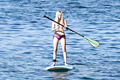 Blonde Ava Sambora paddle boarding in bikini in Hawaii
