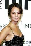 Alicia Vikander posing at awards ceremony