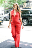 Alicia Silverstone pokies in red jumpsuit