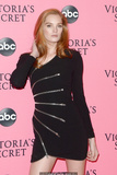 Redhead Alexina Graham in short black dress shows her long sexy legs