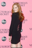 Redhead Alexina Graham in short black dress shows her long sexy legs