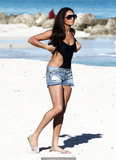 Alesha Dixon in black swimsuit and tiny shorts