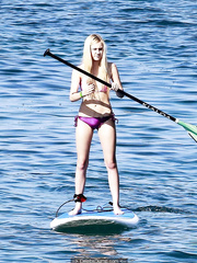 Blonde Ava Sambora paddle boarding in bikini in Hawaii
